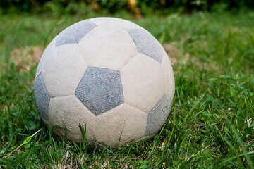 The old football is on grass field.