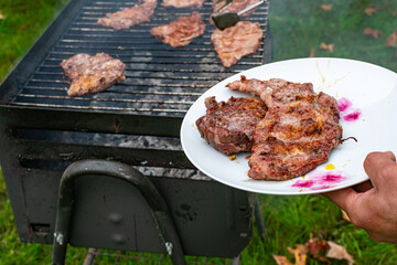 Iberian pork meat grilled on a plate in an outdoor summer lunch