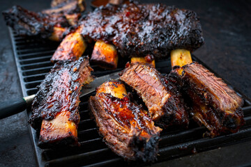 Traditional barbecue burnt chuck beef ribs marinated with spicy rub and served as close-up on a...