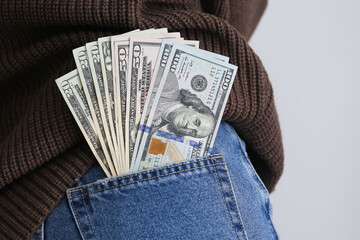 Pocket money background. Dollar bills in rear pocket. Woman with cash. Sexy girl in trousers. Denim jeans cash. Saving money concept. Salary in pocket. Pickpocketing concept background.