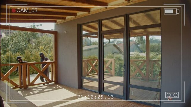 Security Camera Footage Shows Armed Burglars in Masks Forcibly Breaking Into a Home. Importance of Advanced Home Security Systems and Surveillance to Prevent Such Dangerous Criminal Activity.