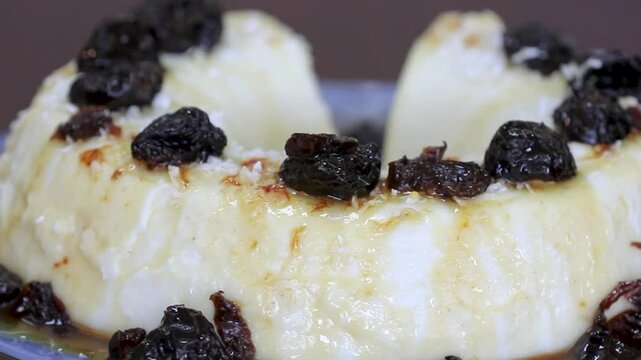 Traditional Brazilian coconut flan dessert known as manjar branco, manjar de coco and manjar dos deuses. Served with plum syrup.