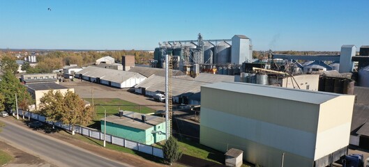 Panorama of a factory for the production of flour and finished bakery products. Huge tall grain elevators. Warehouses for drying and storing grain, wheat, rye, seeds.