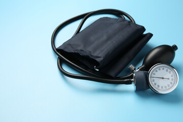 Blood pressure measuring device on light blue background
