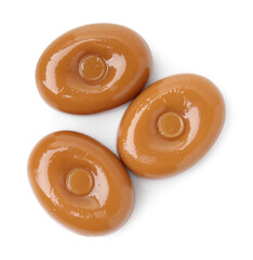 Tasty hard toffee candies isolated on white, top view
