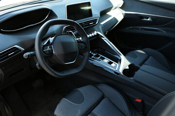 Steering wheel and dashboard inside of modern luxury car, closeup