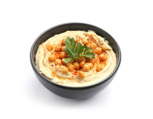 Delicious hummus with parsley, paprika and chickpeas in bowl isolated on white