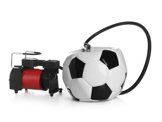 Deflated soccer ball and air compressor isolated on white