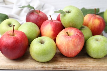 Many fresh ripe apples on table, closeup
