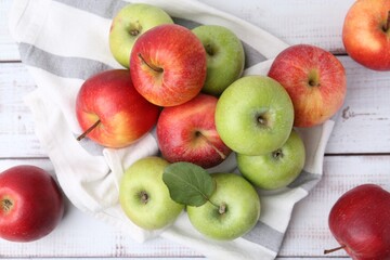Different whole ripe apples on white wooden table, flat lay