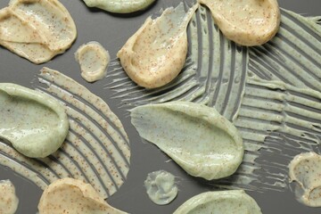 Samples of body scrubs on grey background, flat lay