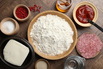 Making calzone pizza. Different ingredients on wooden table, flat lay