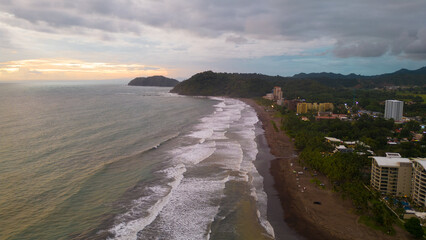 Aerial shot of sunset in the tourist area of ​​Jaco beach town in Puntarenas, Costa Rica