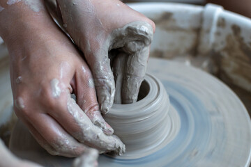 Making of mud pot on potters wheel during workshop in art ceramic atelier in Poland