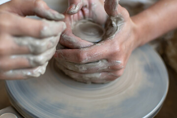 Making of mud pot on potters wheel during workshop in art ceramic atelier in Poland