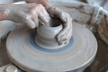 Making of mud pot on potters wheel during workshop in art ceramic atelier in Poland