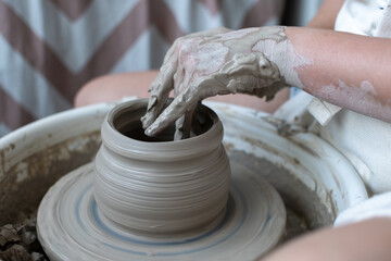 Making of mud pot on potters wheel during workshop in art ceramic atelier in Poland