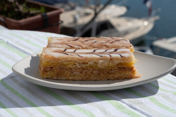 French mille-feuille cake, vanilla or custard slice, Napoleon puff pastry layered with pastry cream served outdoor in Port Grimaud, France