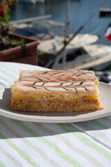French mille-feuille cake, vanilla or custard slice, Napoleon puff pastry layered with pastry cream served outdoor in Port Grimaud, France