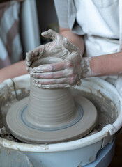 Making of mud pot on potters wheel during workshop in art ceramic atelier in Poland