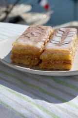 French mille-feuille cake, vanilla or custard slice, Napoleon puff pastry layered with pastry cream served outdoor in Port Grimaud, France