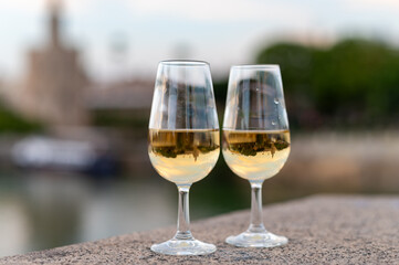 Sherry wine tasting on roof of old Triana district in Sevilla with view on Sevilla houses and river, wine glasses