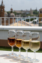 Sherry wine tasting on roof of old Triana district in Sevilla with view on Sevilla houses and churches, wine glasses