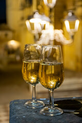 Sherry wine glasses with fino and old church on background at night in Jerez de la Frontera, wine glasses outdoor, cityview, Andalusia, Spain