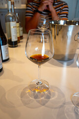 Tasting of sweet Bordeaux white wine in Sauternes, left bank of Gironde Estuary, France. Glasses of white sweet French wine served in restaurant