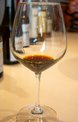 Tasting of sweet Bordeaux white wine in Sauternes, left bank of Gironde Estuary, France. Glasses of white sweet French wine served in restaurant