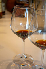 Tasting of sweet Bordeaux white wine in Sauternes, left bank of Gironde Estuary, France. Glasses of white sweet French wine served in restaurant