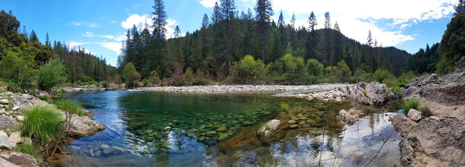 Crystal-Clear Mountain River with Rocky Bed