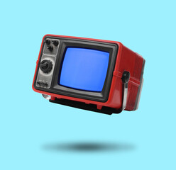 Retro TV set in air on light blue background