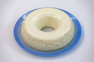 Traditional Brazilian coconut flan dessert known as manjar branco, manjar de coco and manjar dos deuses. Served with plum syrup.