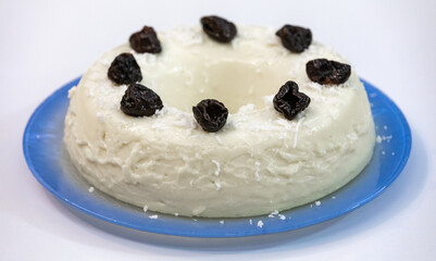 Traditional Brazilian coconut flan dessert known as manjar branco, manjar de coco and manjar dos deuses. Served with plum syrup.