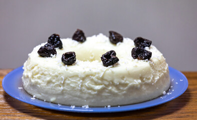 Traditional Brazilian coconut flan dessert known as manjar branco, manjar de coco and manjar dos deuses. Served with plum syrup.