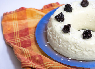 Traditional Brazilian coconut flan dessert known as manjar branco, manjar de coco and manjar dos deuses. Served with plum syrup.