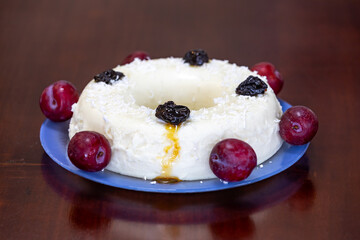 Traditional Brazilian coconut flan dessert known as manjar branco, manjar de coco and manjar dos deuses. Served with plum syrup.