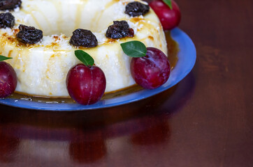 Traditional Brazilian coconut flan dessert known as manjar branco, manjar de coco and manjar dos deuses. Served with plum syrup.