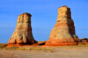 Monument Valley is a region of the Colorado Plateau characterized by a cluster of vast sandstone buttes above the valley floor. It is located on the Arizona-Utah state line, USA