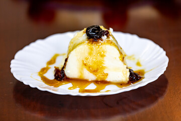 Traditional Brazilian coconut flan dessert known as manjar branco, manjar de coco and manjar dos deuses. Served with plum syrup.