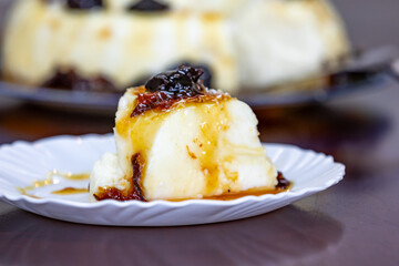 Traditional Brazilian coconut flan dessert known as manjar branco, manjar de coco and manjar dos deuses. Served with plum syrup.