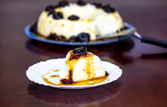 Traditional Brazilian coconut flan dessert known as manjar branco, manjar de coco and manjar dos deuses. Served with plum syrup.