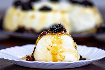 Traditional Brazilian coconut flan dessert known as manjar branco, manjar de coco and manjar dos deuses. Served with plum syrup.