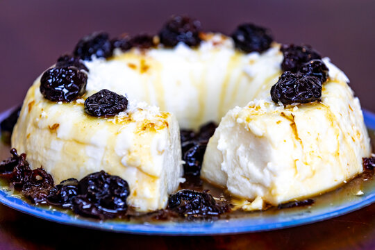 Traditional Brazilian coconut flan dessert known as manjar branco, manjar de coco and manjar dos deuses. Served with plum syrup.