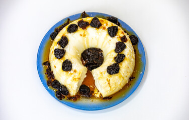 Traditional Brazilian coconut flan dessert known as manjar branco, manjar de coco and manjar dos deuses. Served with plum syrup.