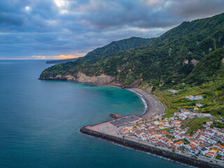 Obraz premium Aerial drone view of Ribeira Quente and Praia do Fogo with volcanic black sand beach. Landscape of Sao Miguel coastline with green mountains in Azores