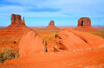 Monument Valley is a region of the Colorado Plateau characterized by a cluster of vast sandstone buttes above the valley floor. It is located on the Arizona-Utah state line, USA