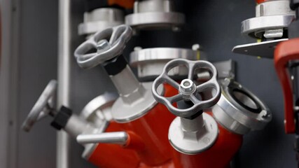 Multi-outlet valve for connecting fire hoses to water source. Valve handles of branch pipe serve to regulate flow and connecting couplings help to interact with other elements