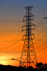 Fototapeta premium High electric pylon and pole in sunset